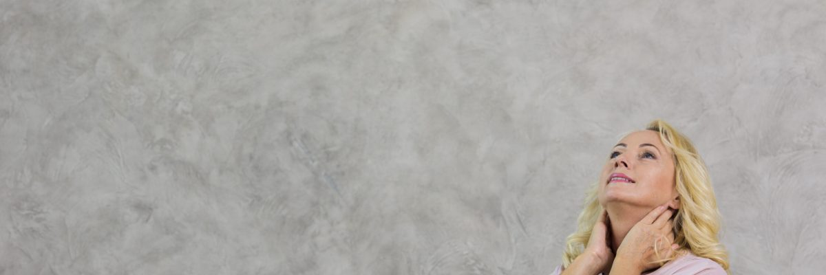 blonde-mature-woman-looking-up-with-copy-space